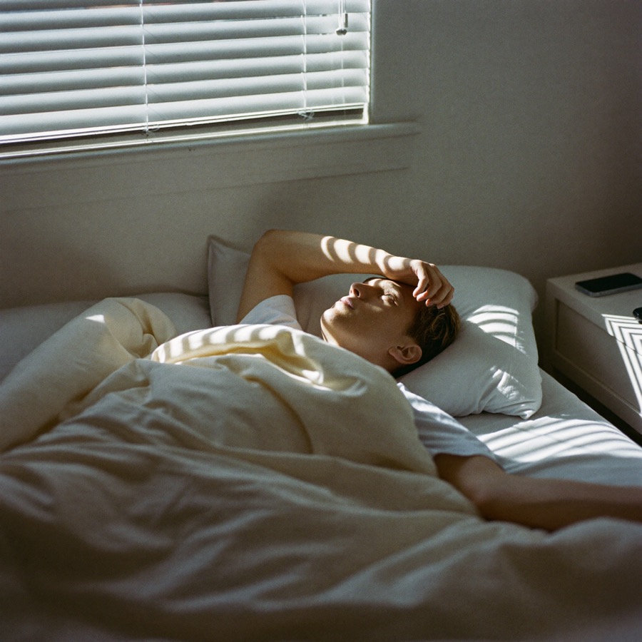 Shift worker lying awake in daylight, unable to sleep